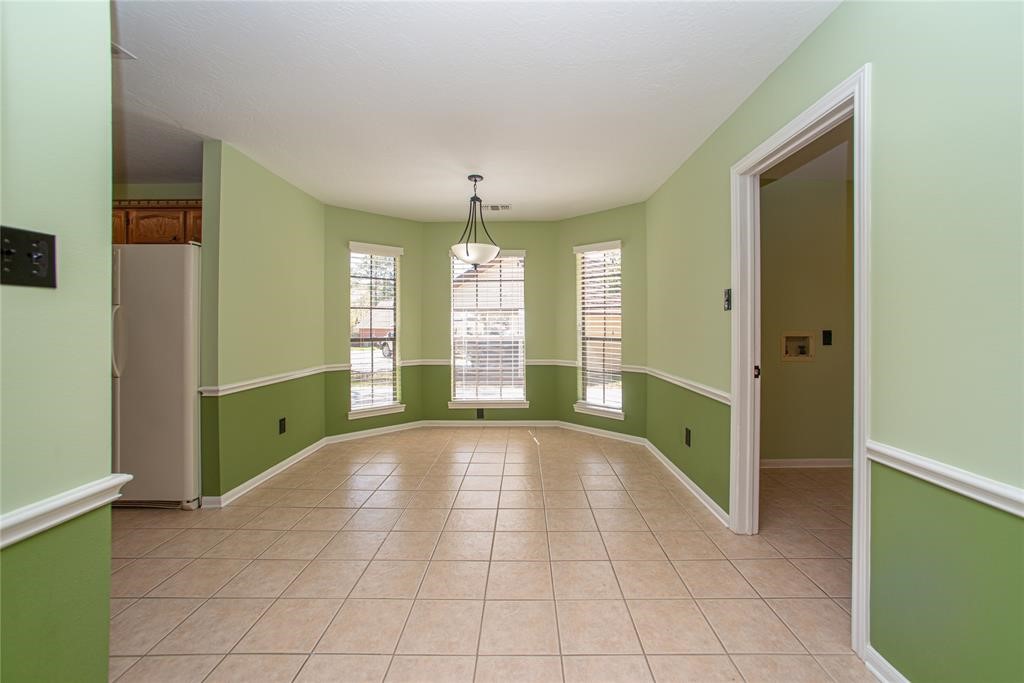 28816 South Diamondhead Conroe, TX 77356 - Photo 9 of 23 a view of an empty room with window and chandelier