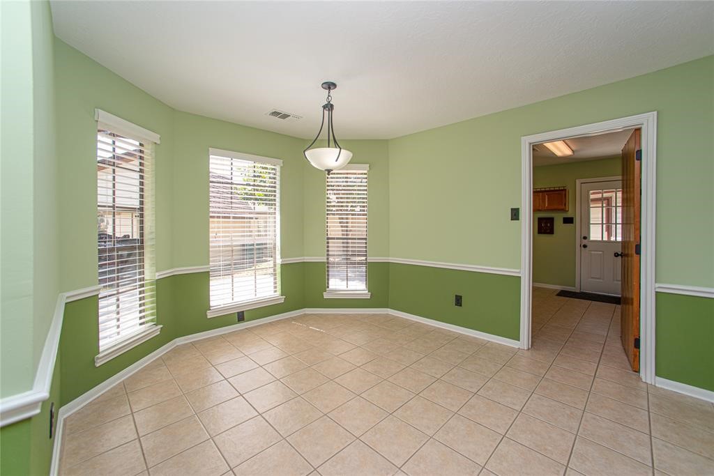 28816 South Diamondhead Conroe, TX 77356 - Photo 10 of 23 a view of an empty room with window and chandelier fan