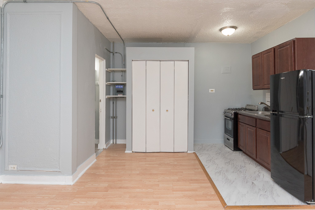 4735 North Beacon Street, Unit 314 Chicago, IL 60640 - Photo 7 of 15 a view of a kitchen with refrigerator and wooden floor
