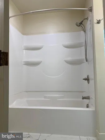 a bathroom with a shower and a bath tub