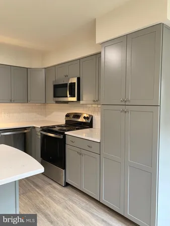 a kitchen with a refrigerator stove and microwave