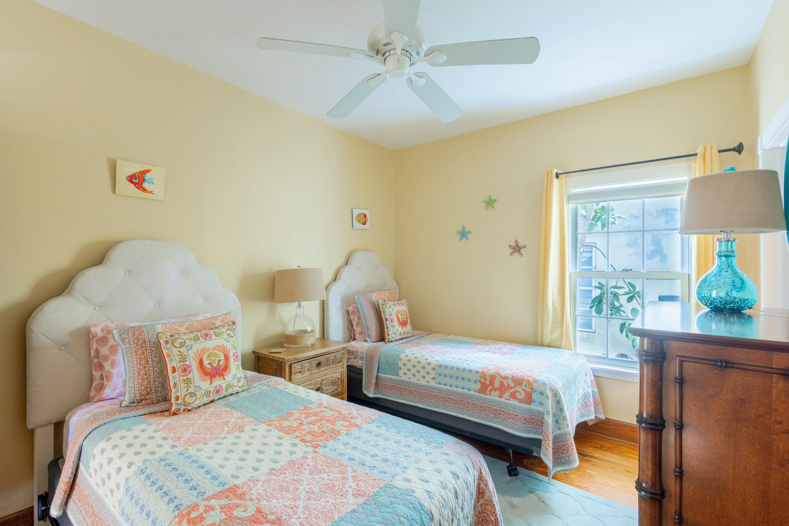 1033 Catherine Street Key West, FL 33040 - Photo 12 of 39 a bedroom with two beds and a chandelier