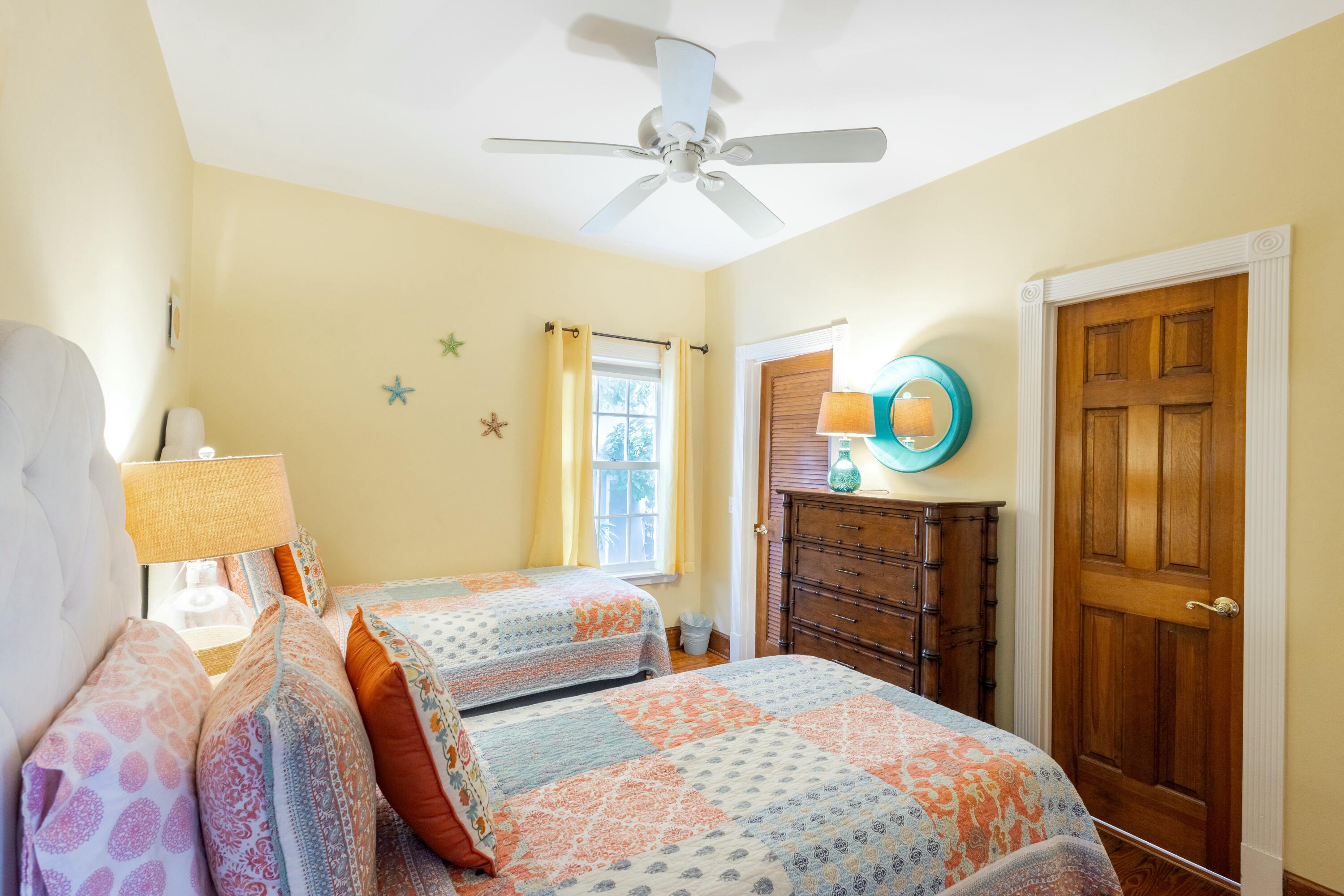 1033 Catherine Street Key West, FL 33040 - Photo 13 of 39 a bedroom with a bed and wooden floor