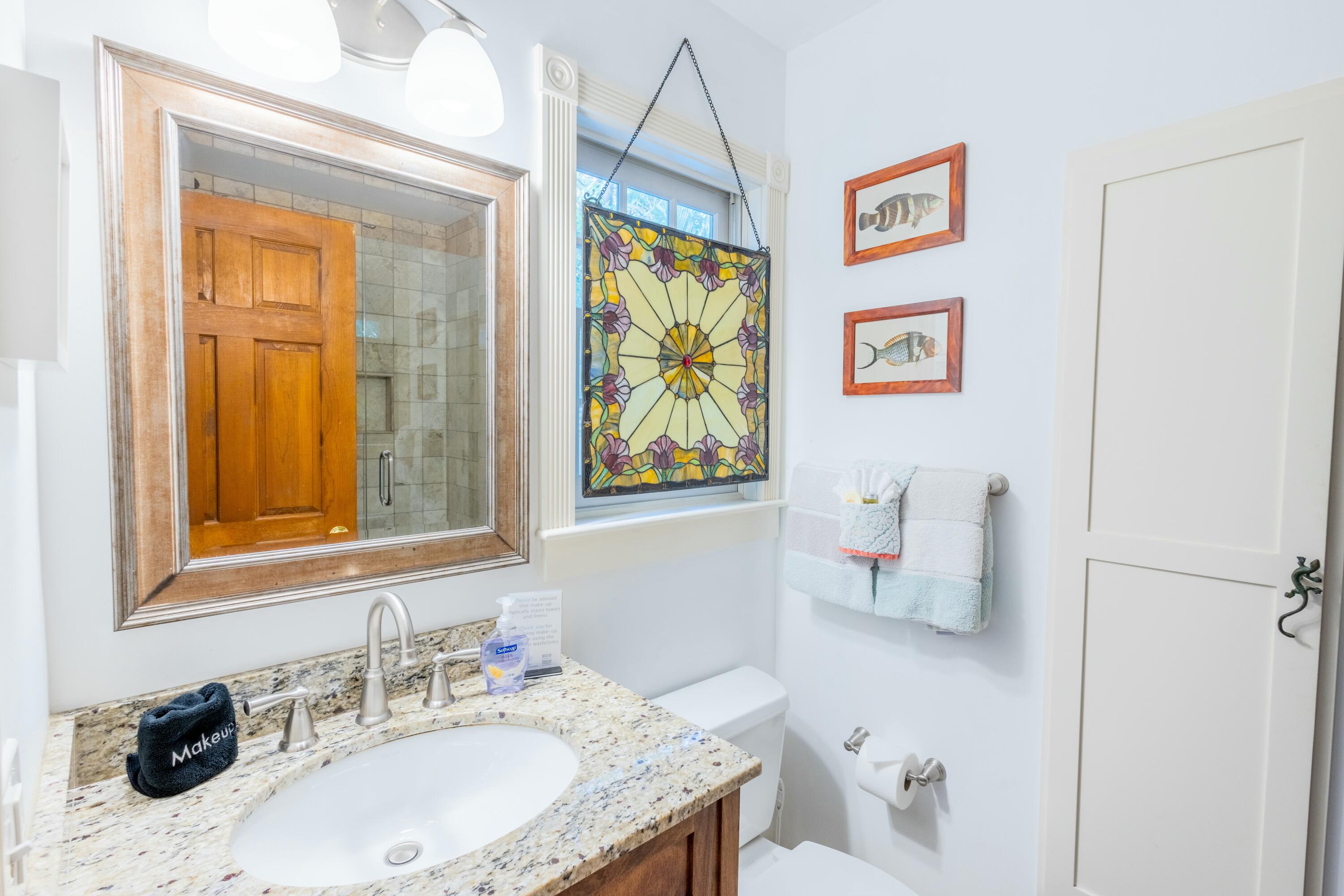 1033 Catherine Street Key West, FL 33040 - Photo 18 of 39 a bathroom with a granite countertop sink a mirror and a shower