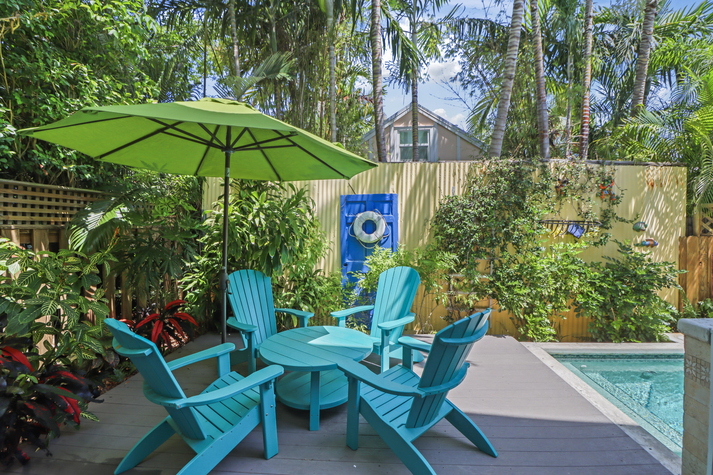 1033 Catherine Street Key West, FL 33040 - Photo 3 of 39 an outdoor space with furniture and umbrella