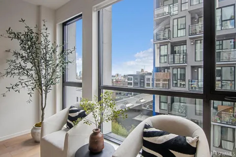 a balcony with furniture and a potted plant