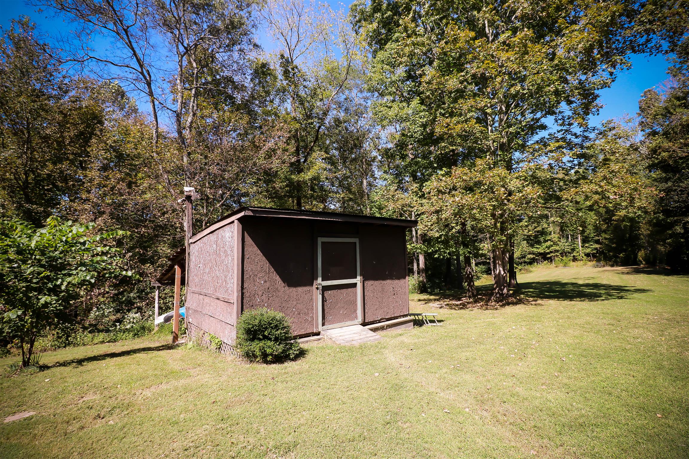 4639 Cathey Ridge Road Manchester, TN 37355 - Photo 21 of 30 a backyard of a house with yard and garage
