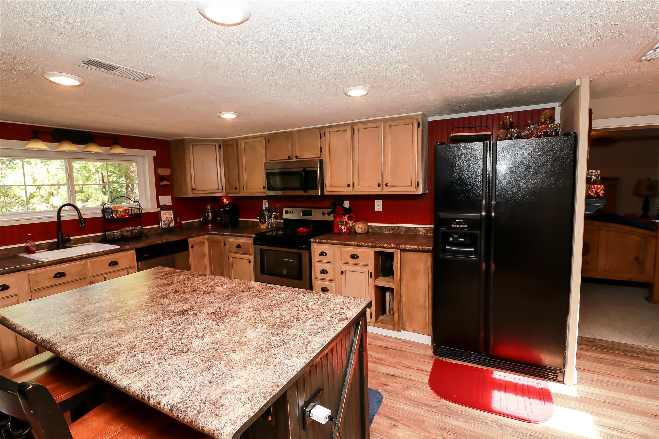 4639 Cathey Ridge Road Manchester, TN 37355 - Photo 7 of 30 a kitchen with stainless steel appliances granite countertop a refrigerator a stove and a sink with wooden floor