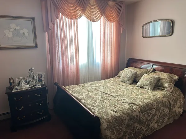 a bedroom with furniture and a window