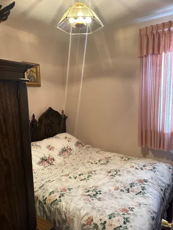 a bed sitting in a bedroom next to a window