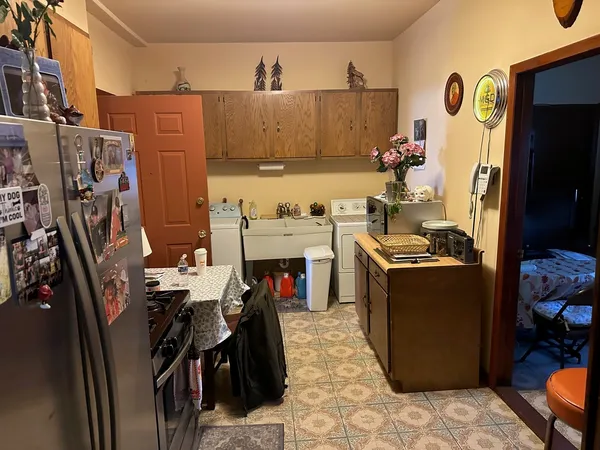 a kitchen with stainless steel appliances granite countertop a sink dishwasher stove and refrigerator