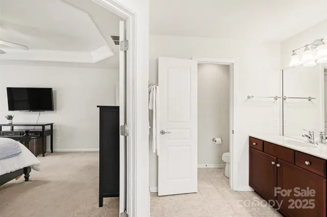 a view of a bathroom with a sink mirror and window