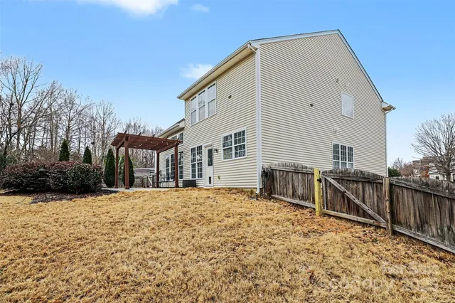 a view of house with wooden fence