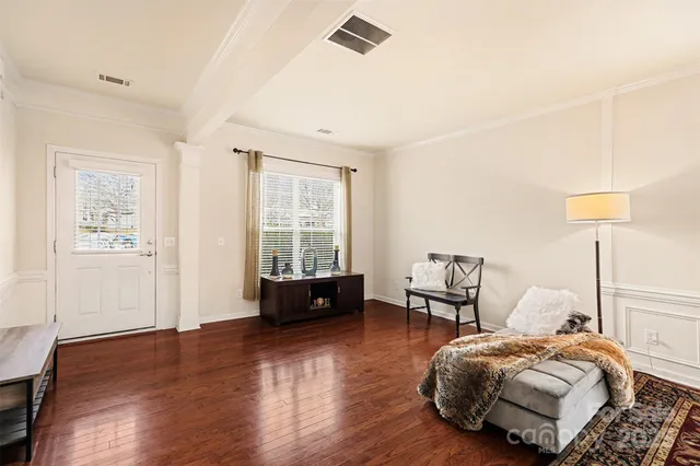 a spacious bedroom with a bed and wooden floor