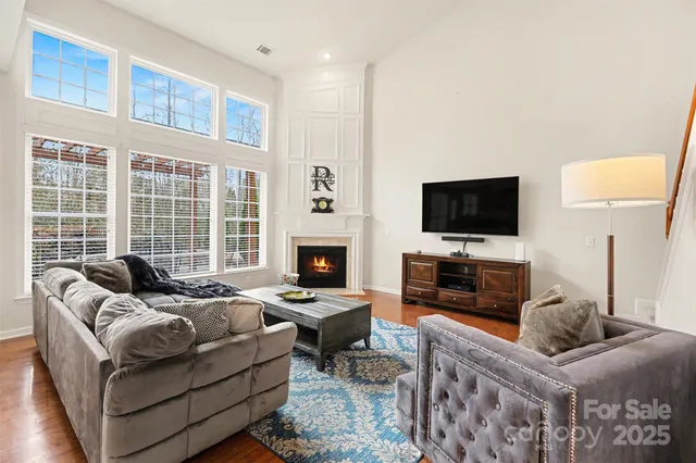 a bedroom with furniture a flat screen tv and a fireplace