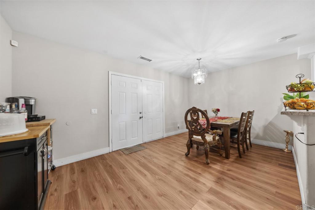 154 East 11th Street Perris, CA 92570 - Photo 12 of 37 a view of a dining room with furniture and wooden floor