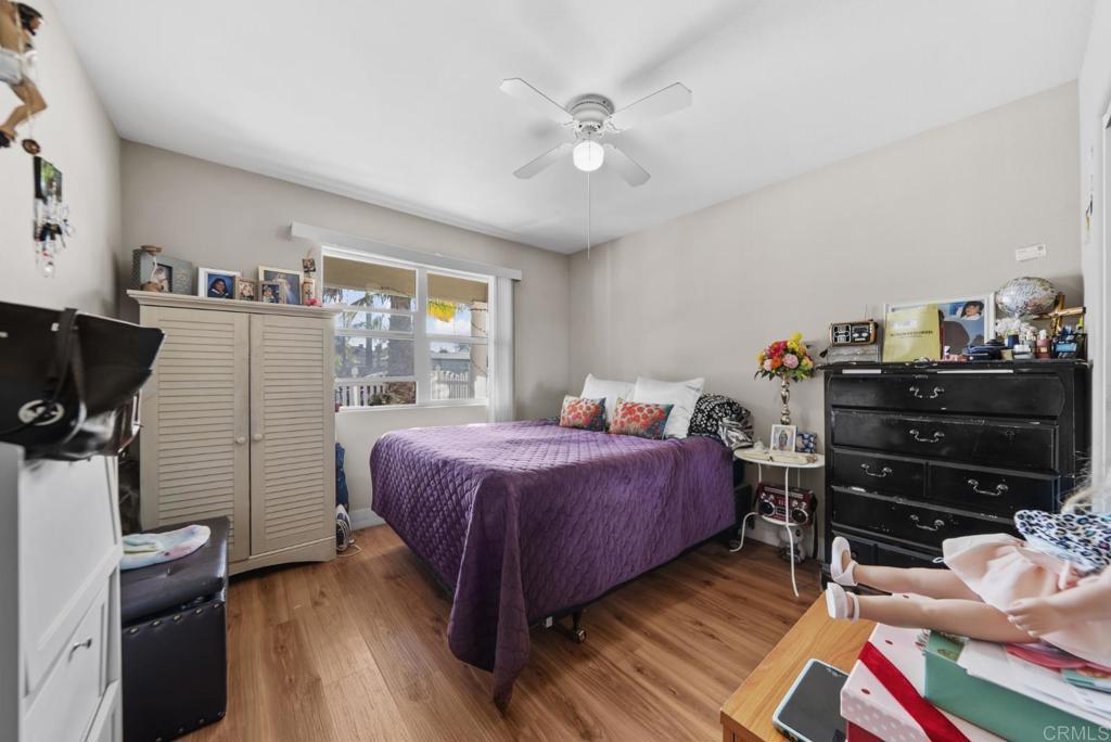 154 East 11th Street Perris, CA 92570 - Photo 13 of 37 a bedroom with a bed and a book shelf