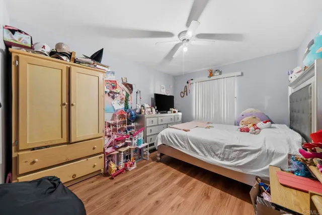 a bedroom with a bed and flat screen tv