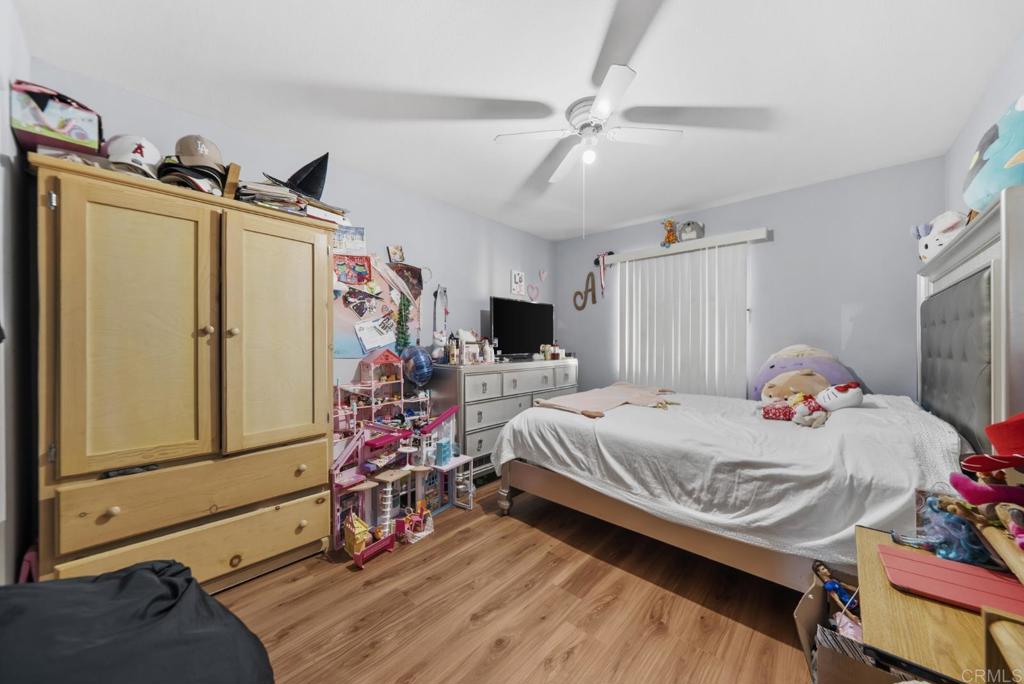 154 East 11th Street Perris, CA 92570 - Photo 15 of 37 a bedroom with a bed and flat screen tv