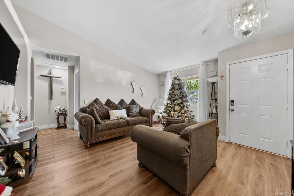 154 East 11th Street Perris, CA 92570 - Photo 3 of 37 a living room with furniture and a flat screen tv