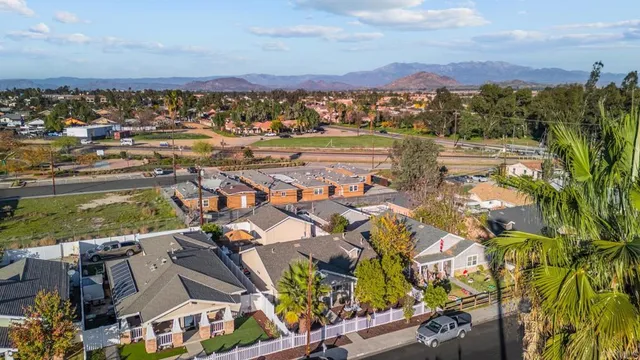 an aerial view of residential building with parking and ocean view