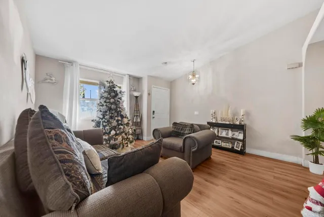 a living room with furniture window and wooden floor