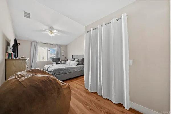 a bedroom with a large bed and a chandelier