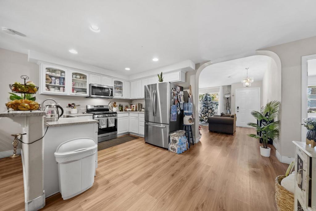 154 East 11th Street Perris, CA 92570 - Photo 9 of 37 a kitchen with sink refrigerator and microwave