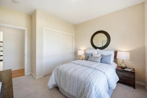 a bedroom with a bed and a lamp