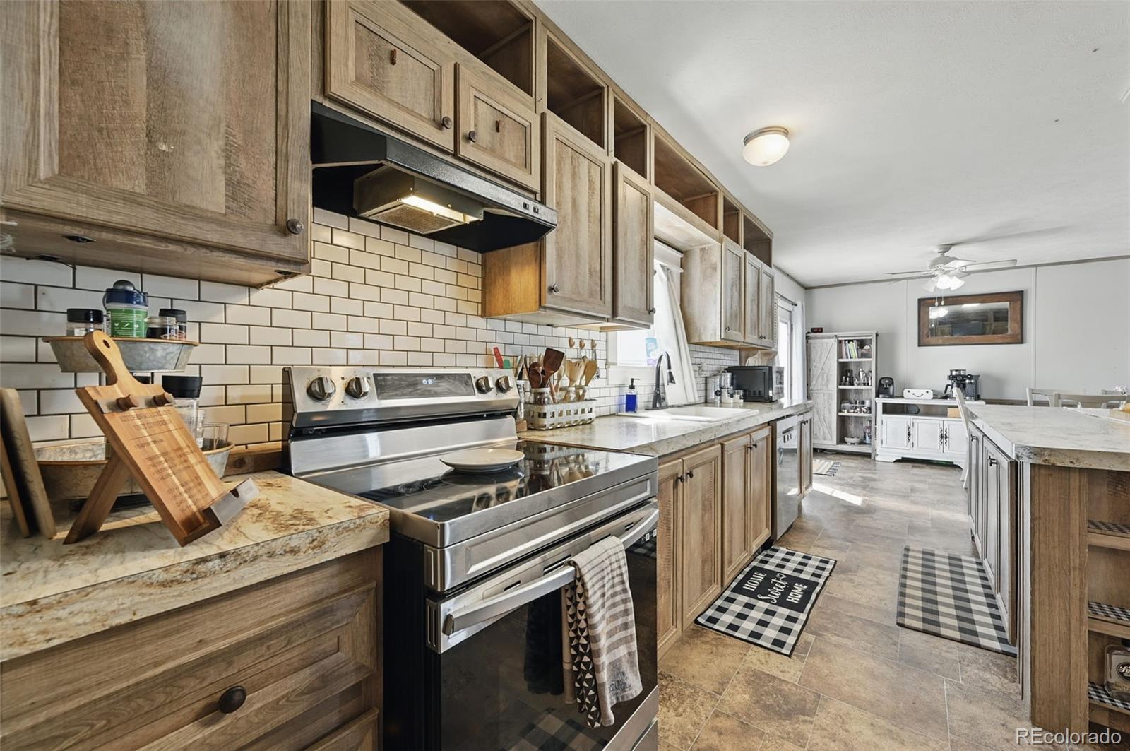 30890 Ken View Yoder, CO 80864 - Photo 11 of 36 a kitchen with stainless steel appliances granite countertop a stove and a sink