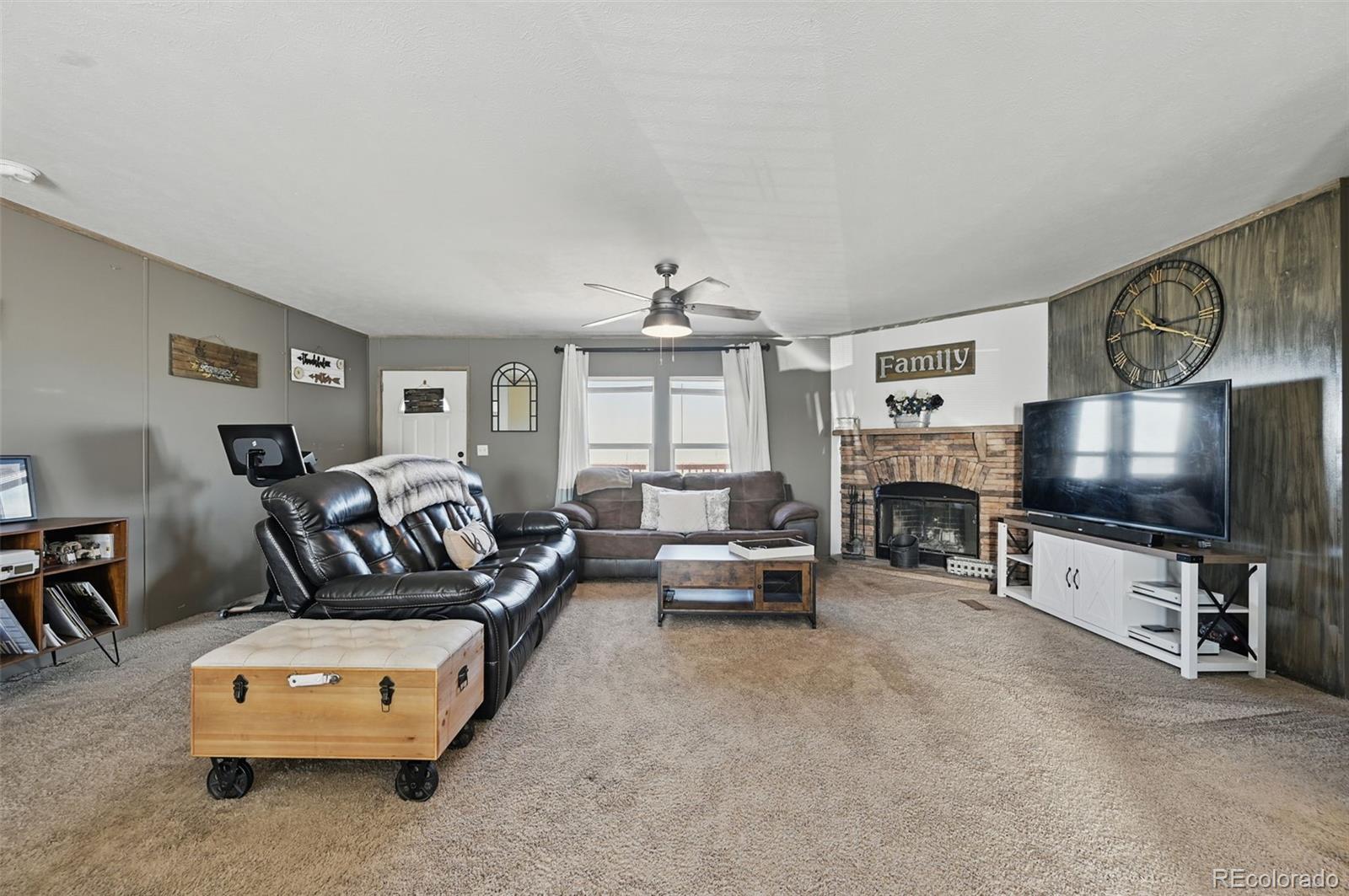 30890 Ken View Yoder, CO 80864 - Photo 13 of 36 a living room with furniture and a flat screen tv