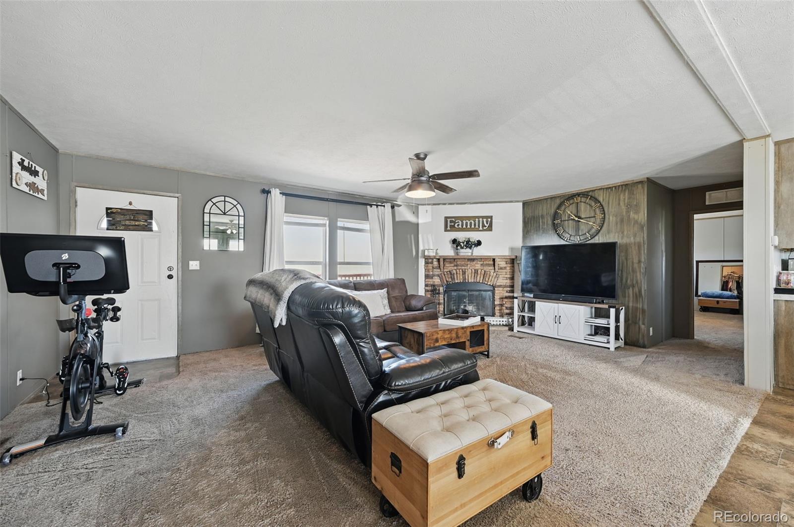 30890 Ken View Yoder, CO 80864 - Photo 14 of 36 a living room with furniture and a flat screen tv