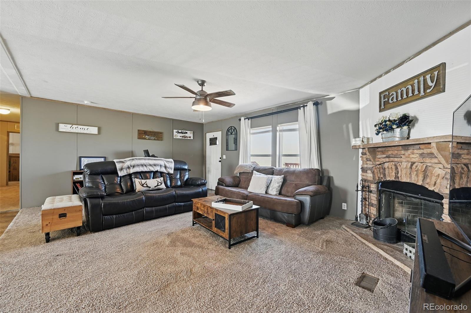 30890 Ken View Yoder, CO 80864 - Photo 15 of 36 a living room with furniture and a fireplace