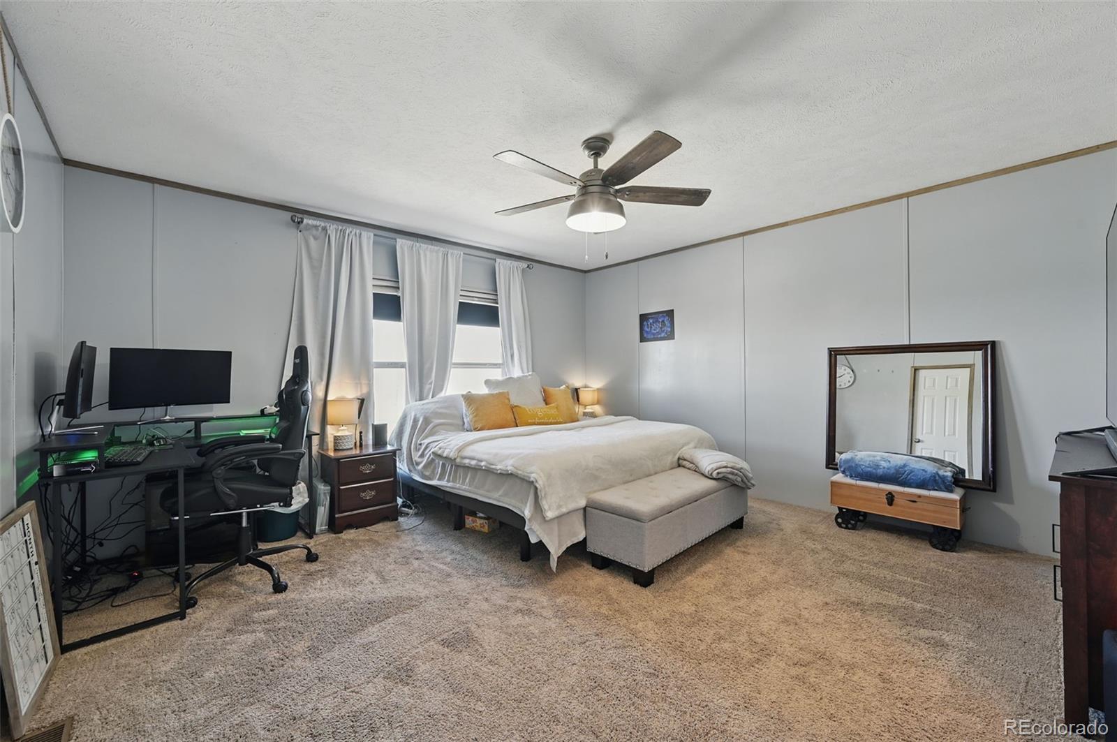 30890 Ken View Yoder, CO 80864 - Photo 17 of 36 a bedroom with a bed a flat screen tv and dresser