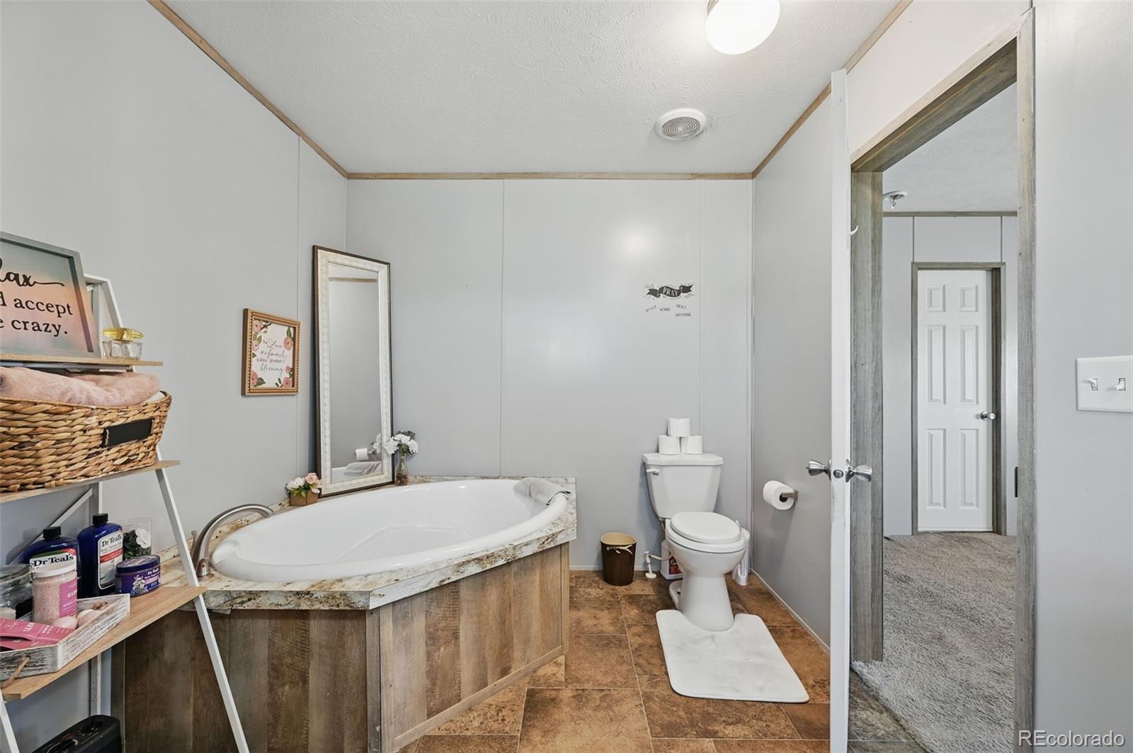 30890 Ken View Yoder, CO 80864 - Photo 20 of 36 a bathroom with a granite countertop sink toilet and shower