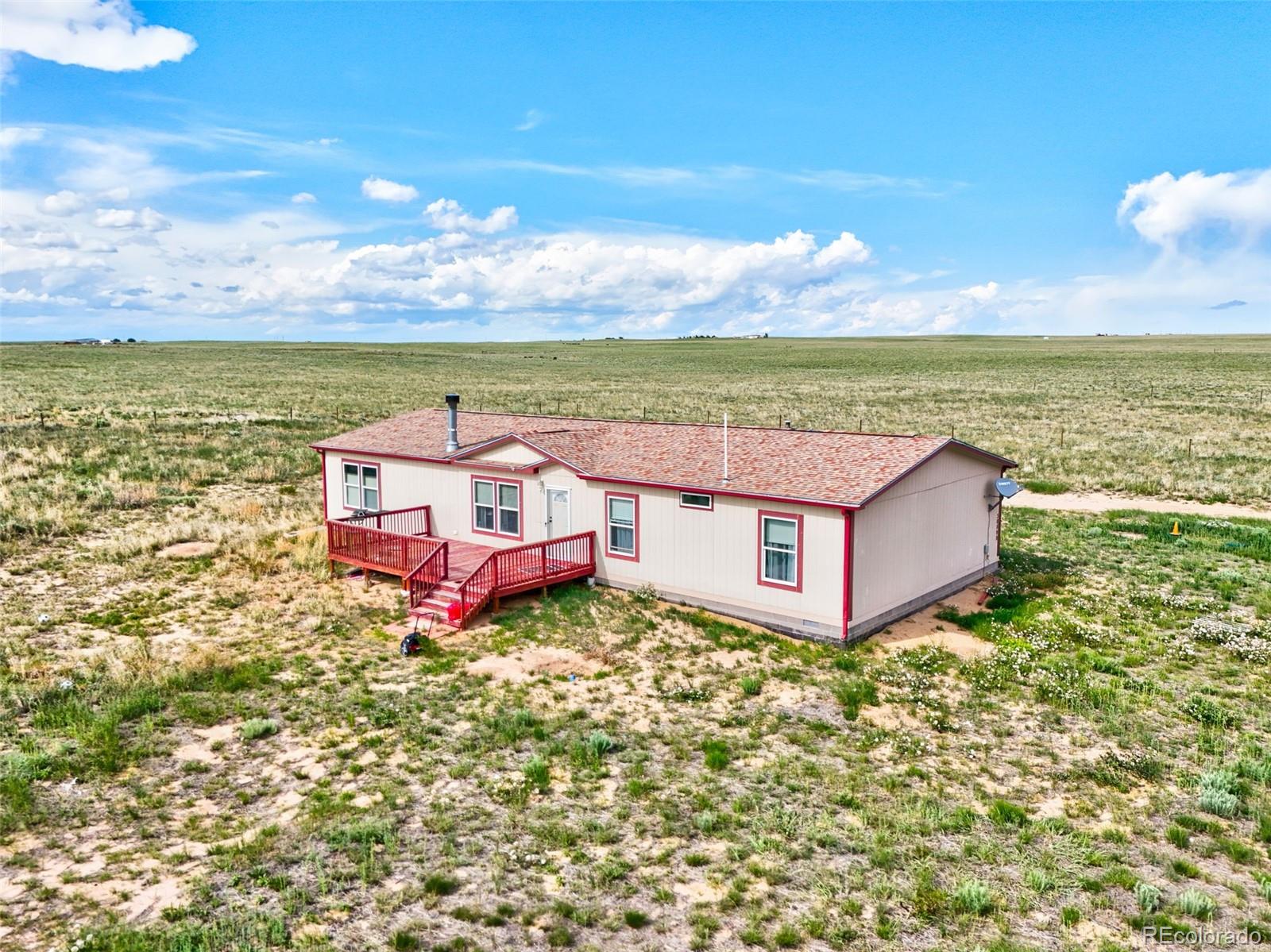 30890 Ken View Yoder, CO 80864 - Photo 2 of 36 a aerial view of a house with yard and ocean view