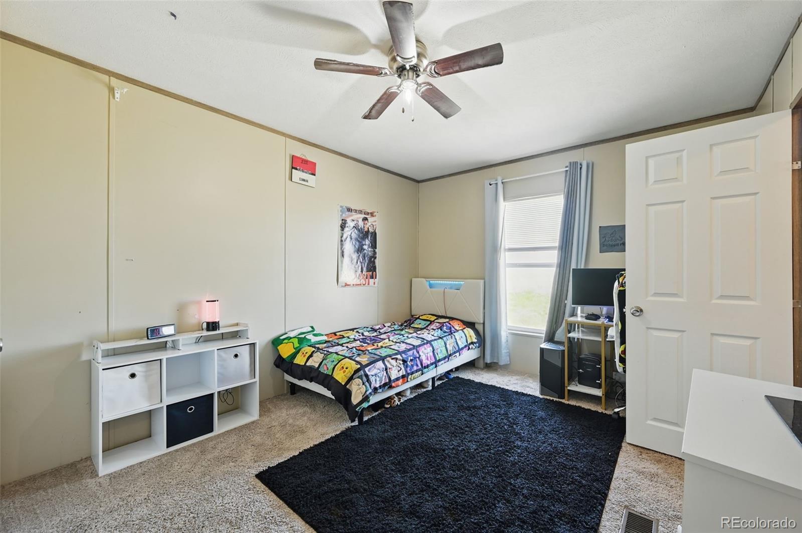 30890 Ken View Yoder, CO 80864 - Photo 23 of 36 a bedroom with a bed and a chandelier