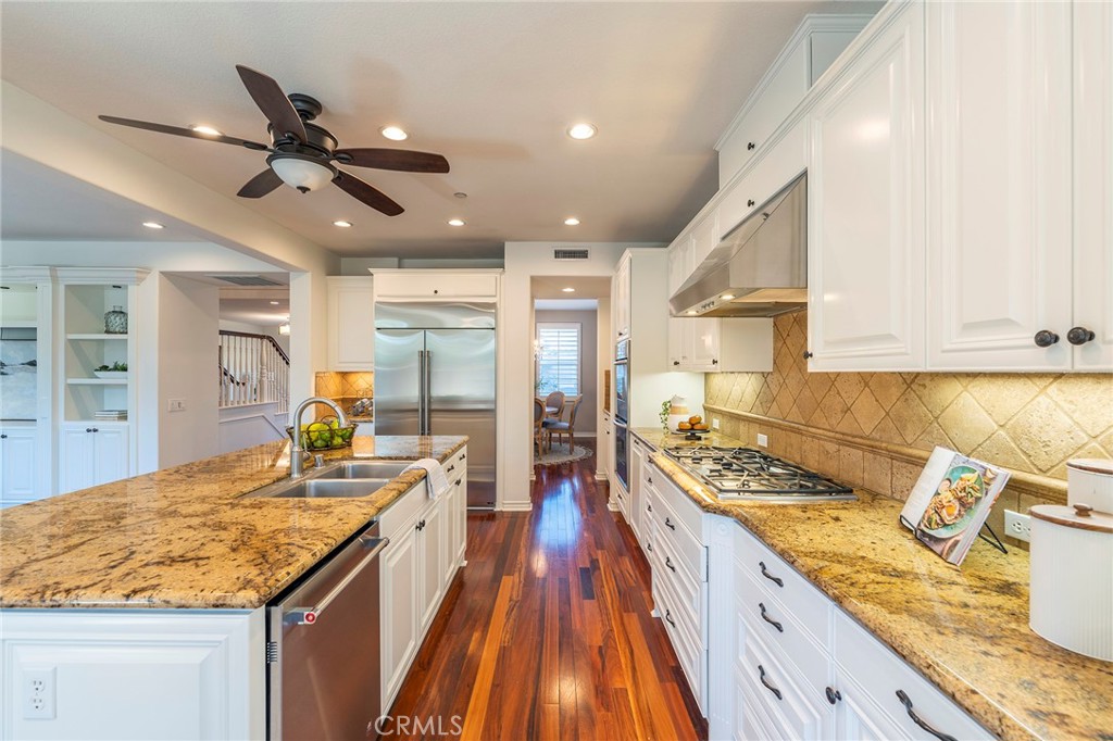 6 Shepherd Court Ladera Ranch, CA 92694 - Photo 11 of 68 a large kitchen with kitchen island a counter space a sink stainless steel appliances and cabinets