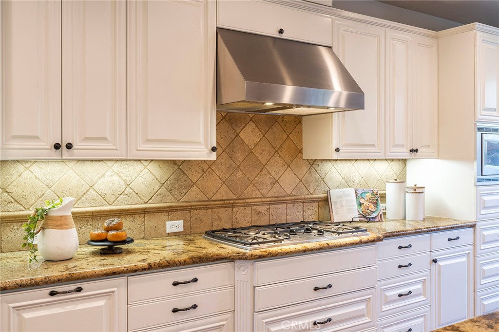 6 Shepherd Court Ladera Ranch, CA 92694 - Photo 18 of 68 a kitchen with granite countertop stainless steel appliances stove top oven and cabinets
