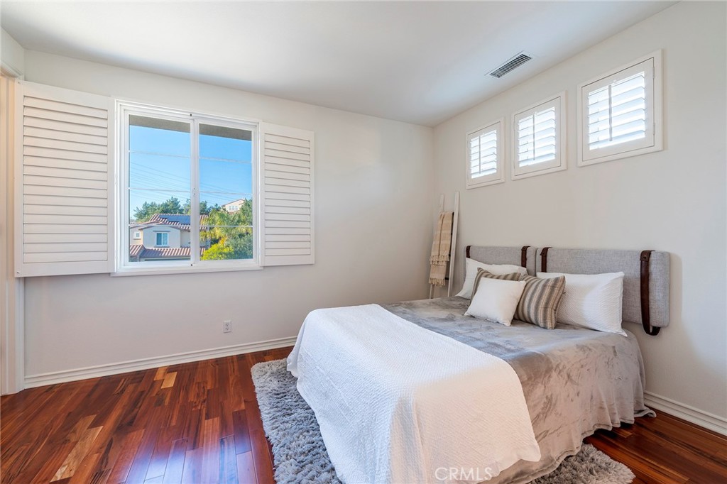 6 Shepherd Court Ladera Ranch, CA 92694 - Photo 29 of 68 a bedroom with a bed and wooden floor