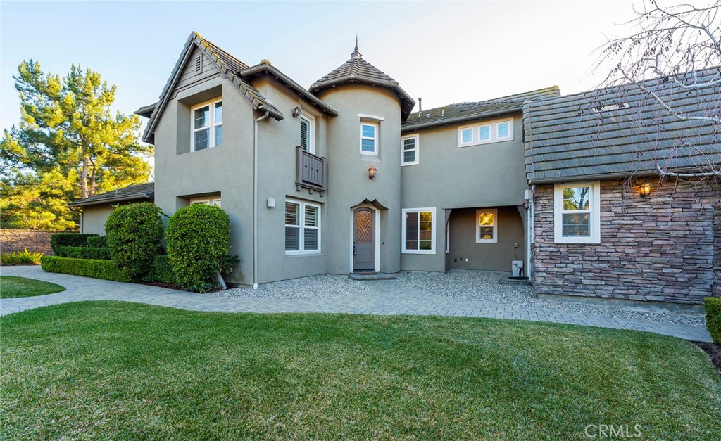 6 Shepherd Court Ladera Ranch, CA 92694 - Photo 42 of 68 a view of a brick house with a large windows and a yard
