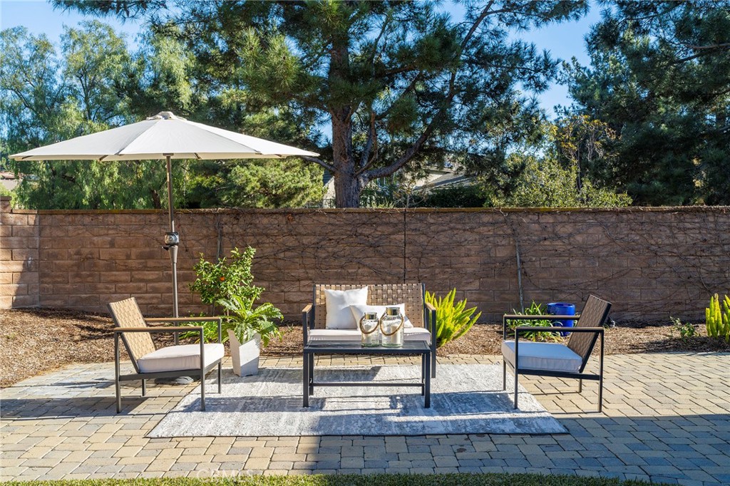 6 Shepherd Court Ladera Ranch, CA 92694 - Photo 46 of 68 a view of a tables and chairs under an umbrella in the patio