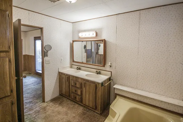 a view of a porch with wooden floor and fence