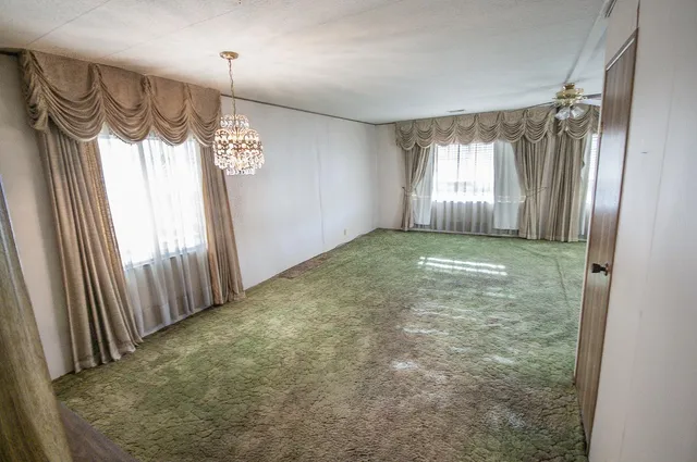 a room with lots of furniture and windows