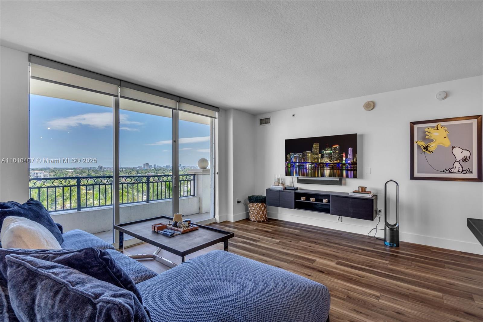 a living room with furniture large window and flat screen tv