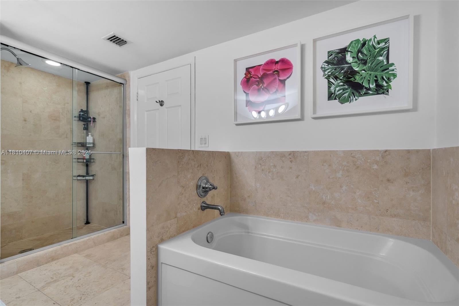 3232 Southwest 22nd Terrace, Unit 1106 Miami, FL 33145 - Photo 12 of 22 a bath tub sitting next to a white sink and vanity