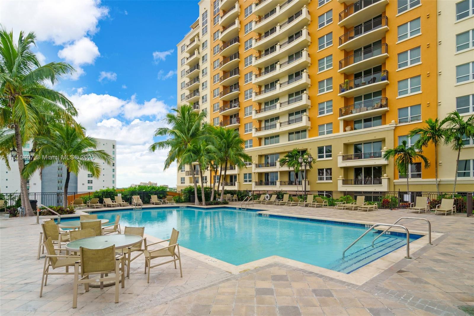 3232 Southwest 22nd Terrace, Unit 1106 Miami, FL 33145 - Photo 18 of 22 a view of swimming pool with outdoor seating and lake view