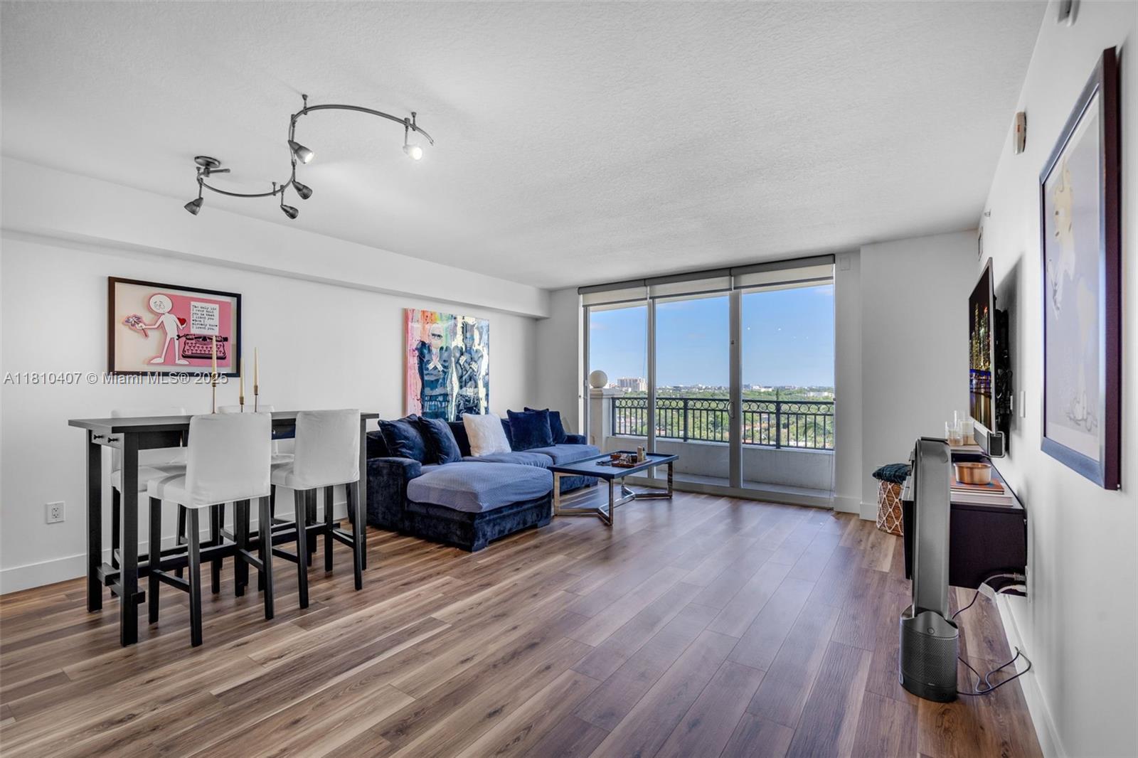 3232 Southwest 22nd Terrace, Unit 1106 Miami, FL 33145 - Photo 2 of 22 a living room with furniture floor to ceiling window and wooden floor