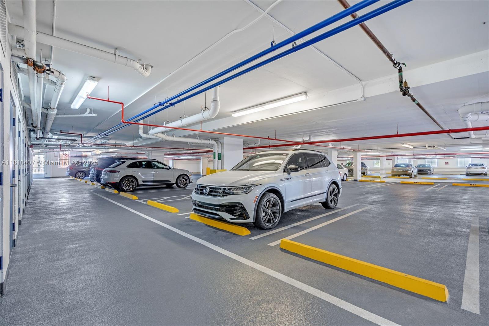 3232 Southwest 22nd Terrace, Unit 1106 Miami, FL 33145 - Photo 22 of 22 a view of parking garage with cars parked