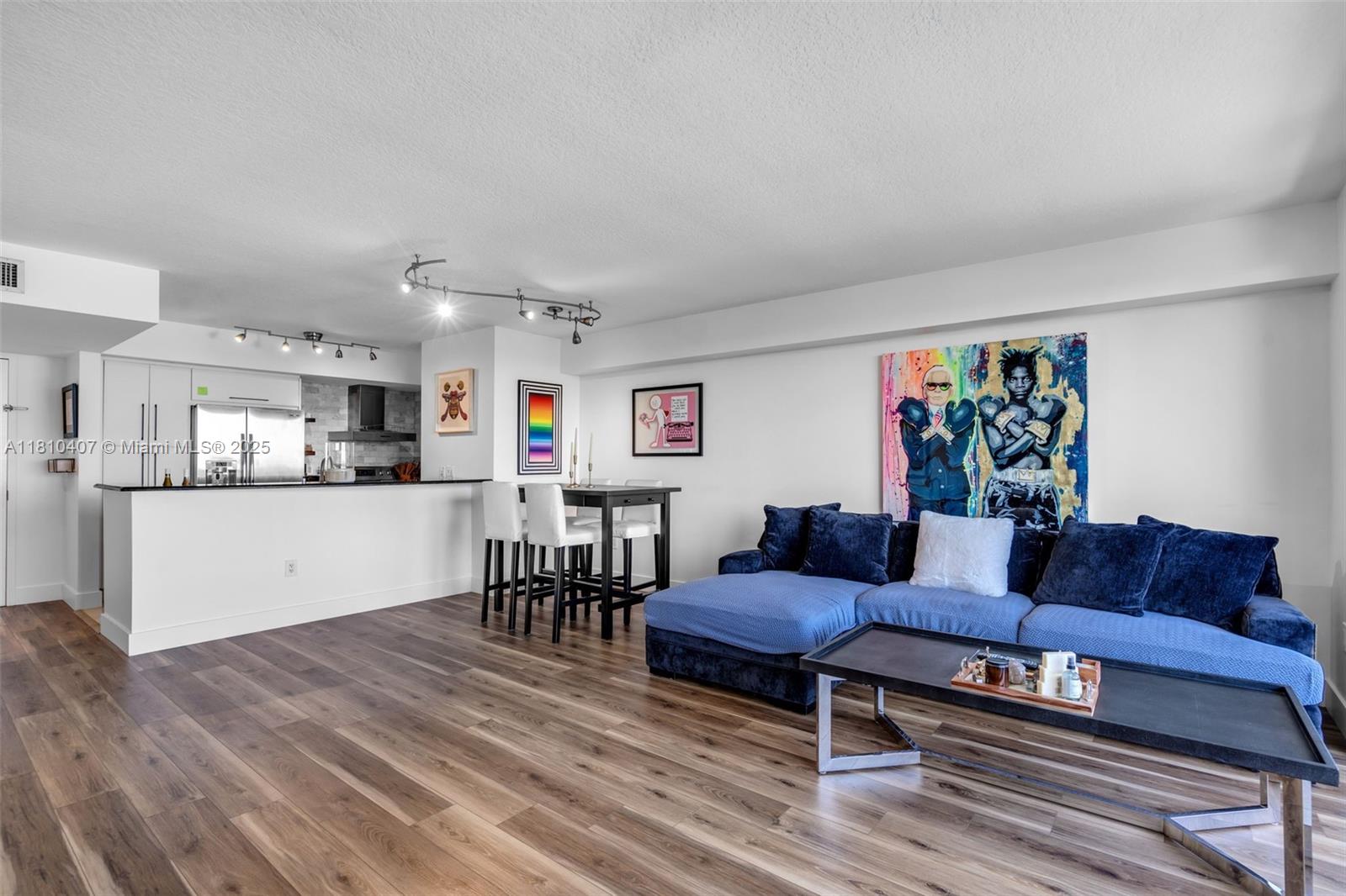 3232 Southwest 22nd Terrace, Unit 1106 Miami, FL 33145 - Photo 3 of 22 a living room with furniture and a wooden floor